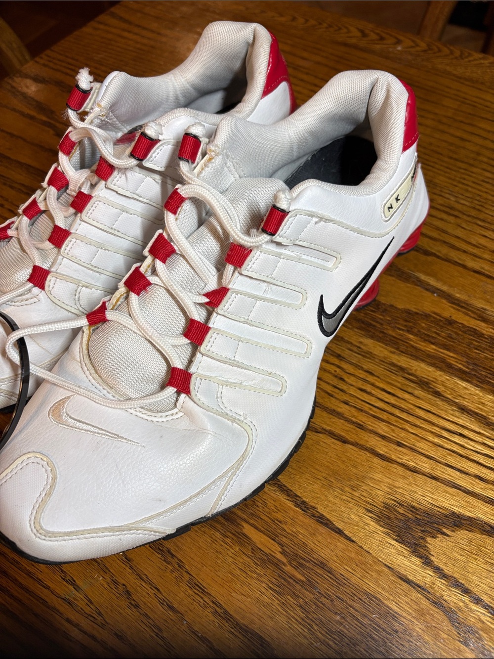Nike White Athletic Shoes with Red Accents and Black Swoosh